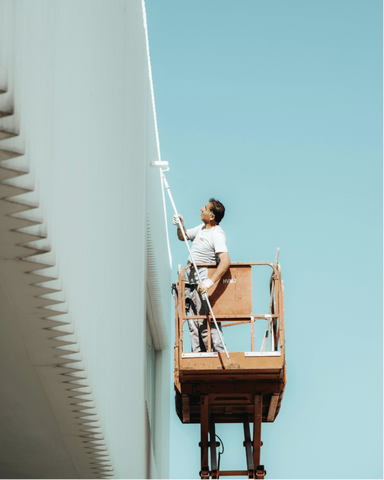 Man painting on aerial lift